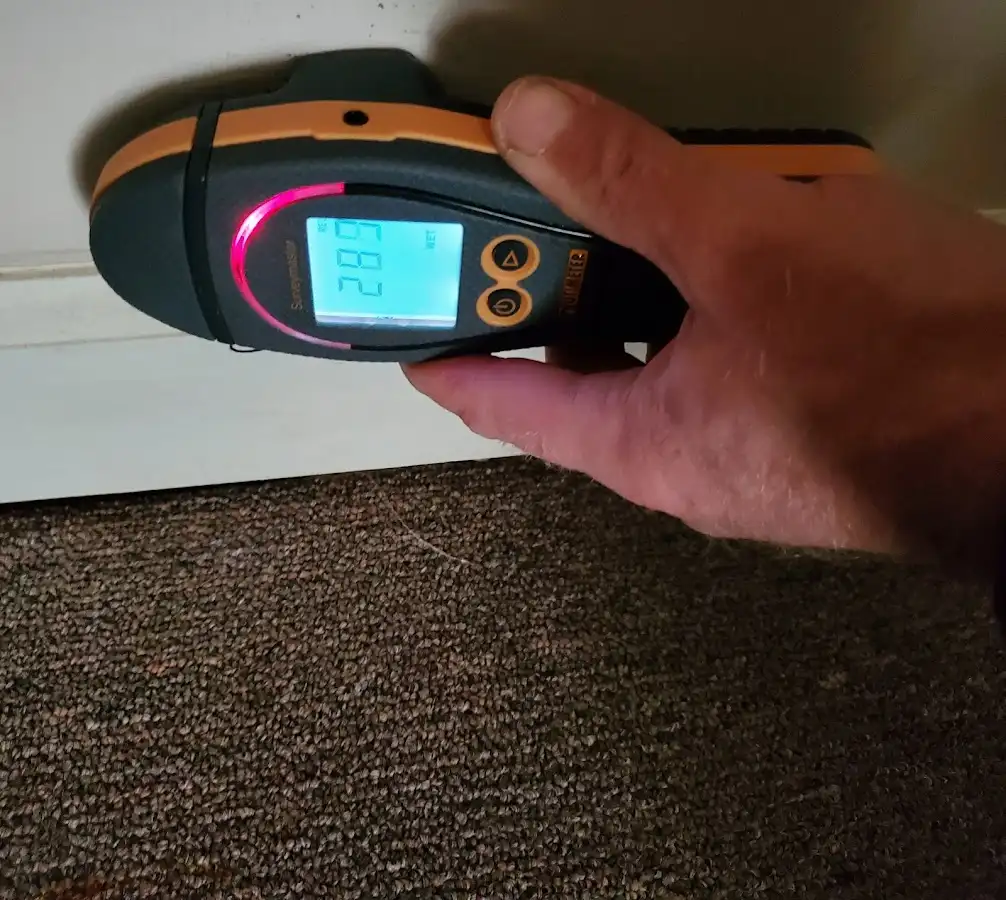 Moisture detection at baseboard during Storm Damage Restoration in Corcoran